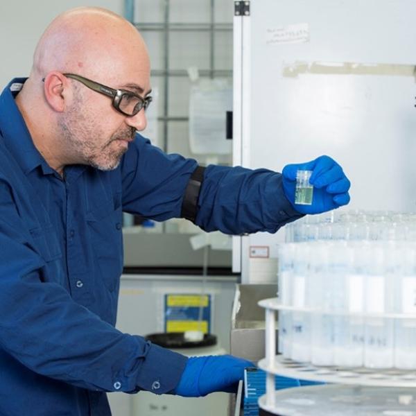 Scientist holding a vial