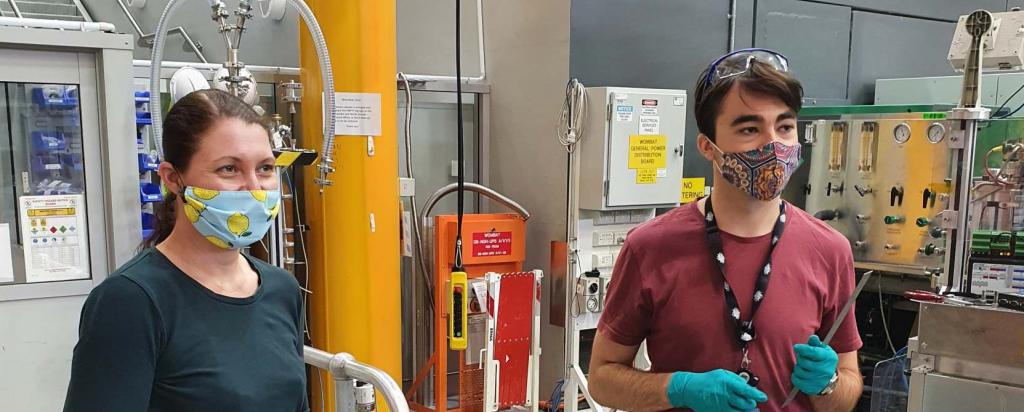 Monica and Hamish preparing pyrite powder mineral samples for neutron diffraction measurements using the Wombat instrument at ACNS