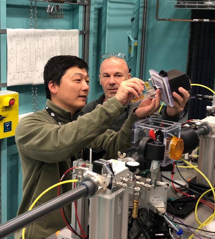 Two men setting up scientific equipment 